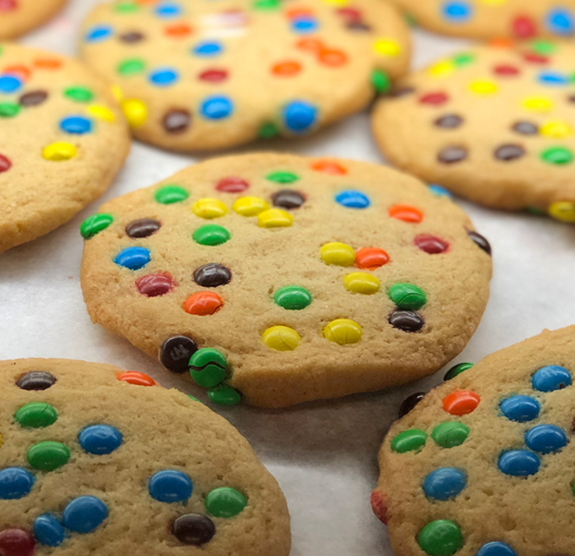 A closeup of fresh M&M cookies.